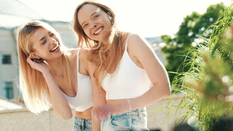 two happy women laughing outdoors