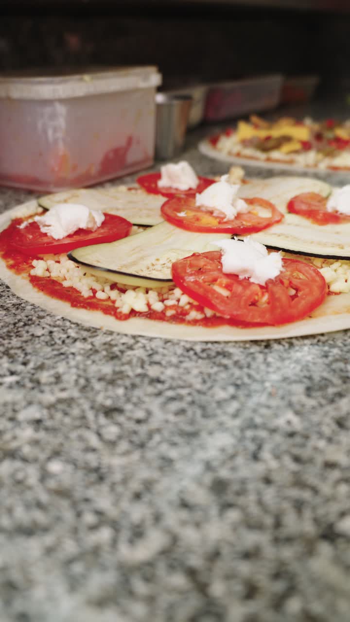 Pizza Preparation with Tomato, Eggplant, and Cheese