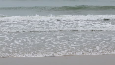 rayong beach while rain and strong waves in the rainy season. cloudy rainy weather with strong wind