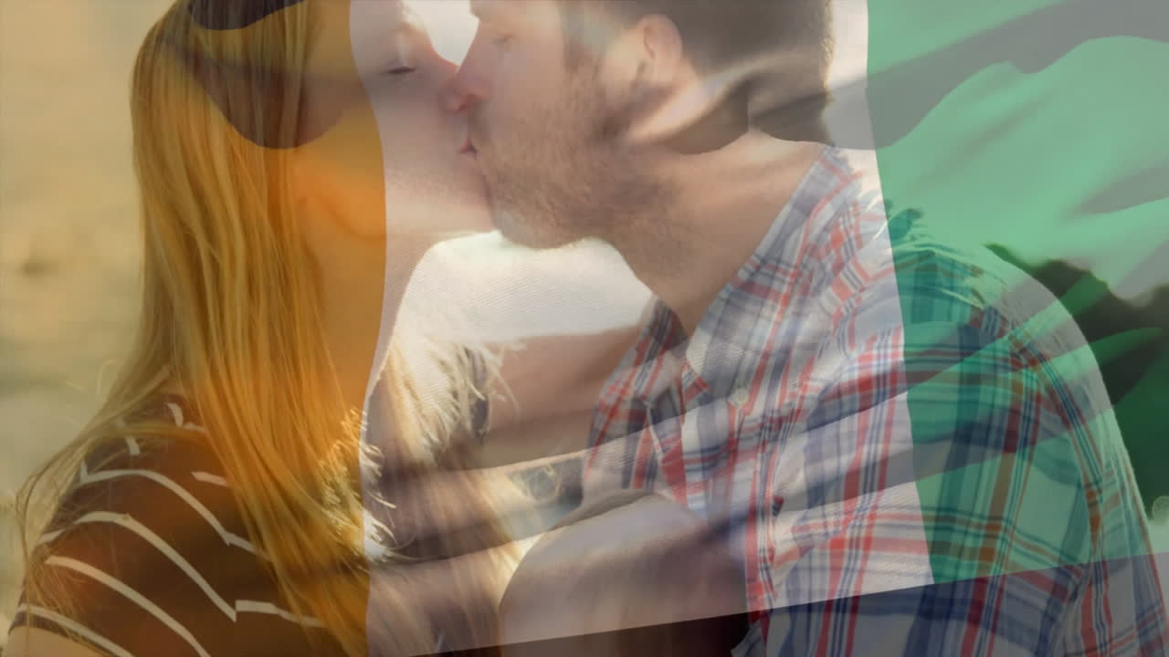 Kissing couple with Irish flag animation overlay in romantic outdoor setting