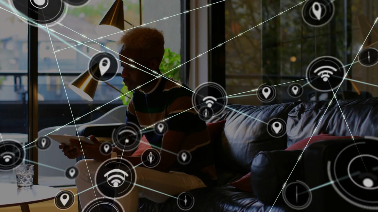 Adult man tapping tablet on couch, initiating Wi-Fi pins and nodes visualizing tech network overlay
