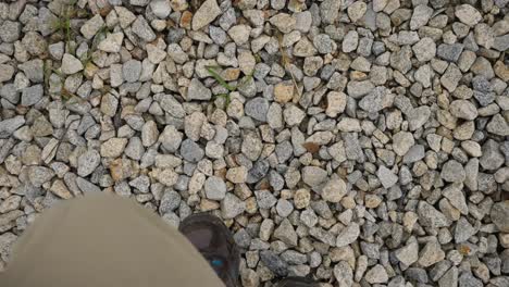 person walking on gravel path