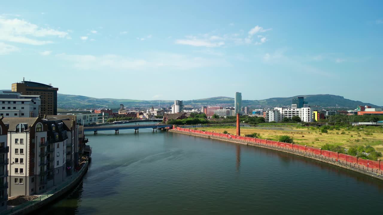 Front-on aerial GV of the River Lagan in Belfast City Centre, Northern Ireland, UK on a bright and sunny day. Produced in 4K, 60FPS and with Rec709 color