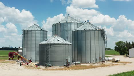 industrial agricultural farming grain bin silos on countryside farm