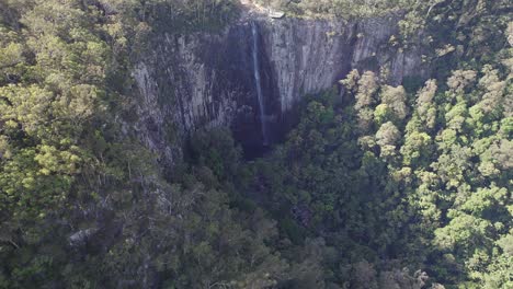 aerial view over minyon falls surrounded with lush rainforest in qld, australia - drone shot