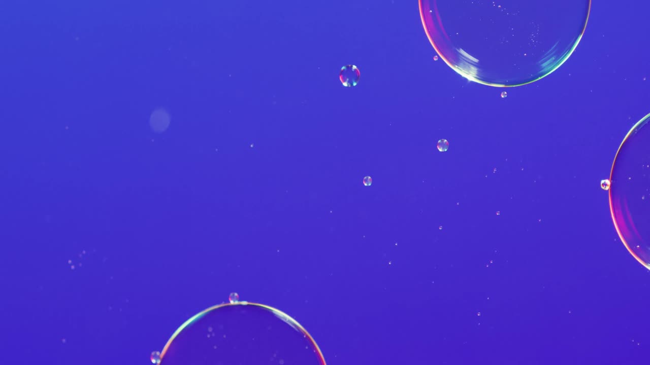 Animation of bubbles moving on blue background with copy space