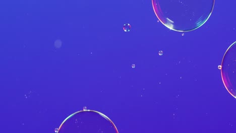 Animation-of-bubbles-moving-on-blue-background-with-copy-space
