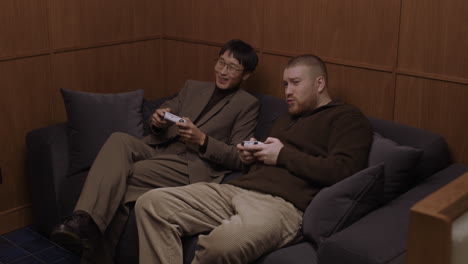 two friends enjoying a gaming session on a couch