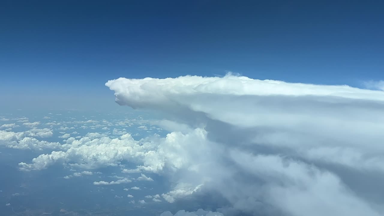 A pilot&rsquo;s perspective of a huge storm cloud from above while flying at 12000m high