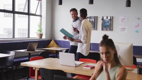 happy diverse business people discussing work during meeting at office