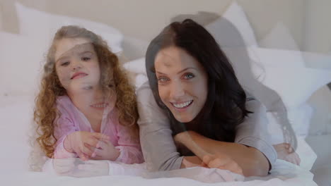 mother and daughter lying on the bed