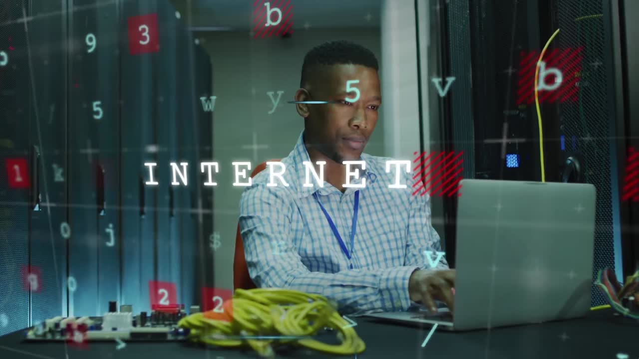 Animation of letters and texts over african american man working on laptop in server room