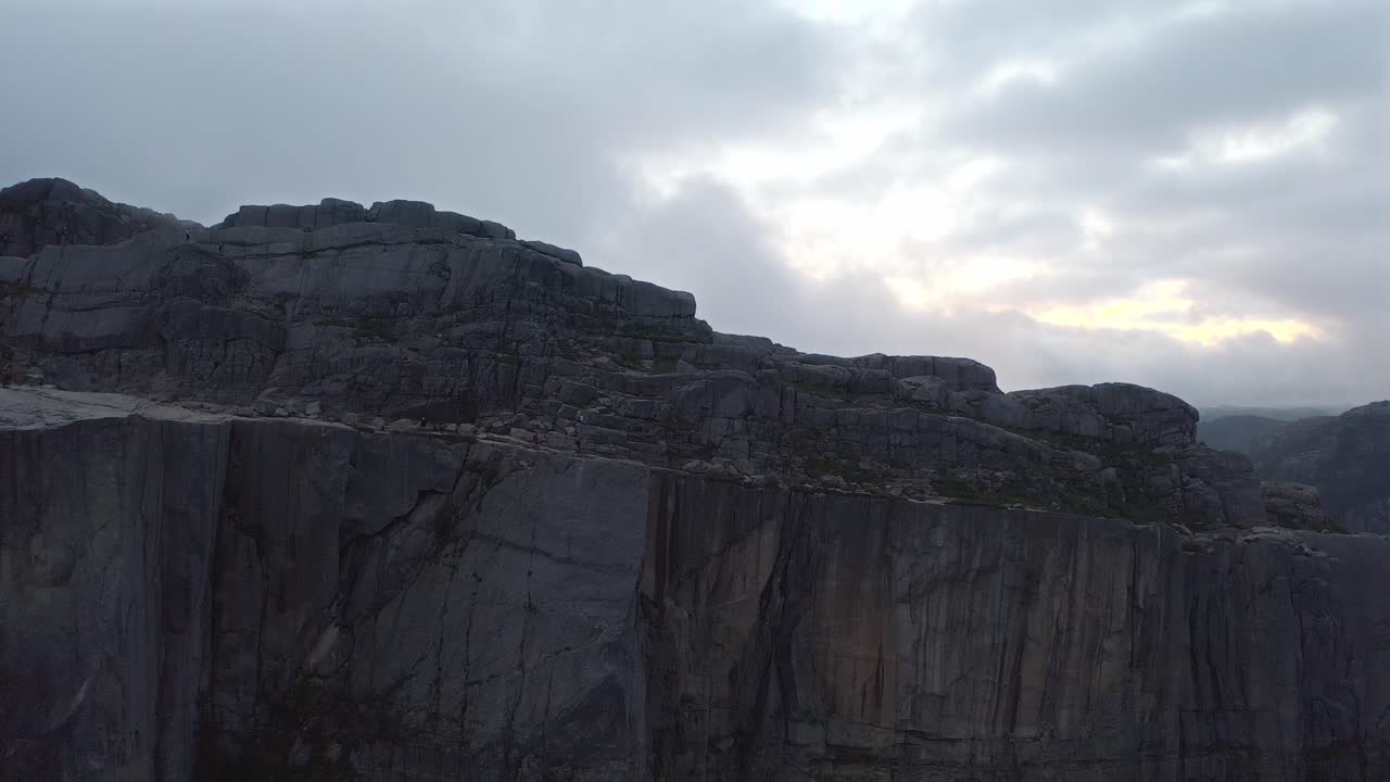 Majestic Norwegian cliffs under a soft cloudy sky, captured from an aerial view