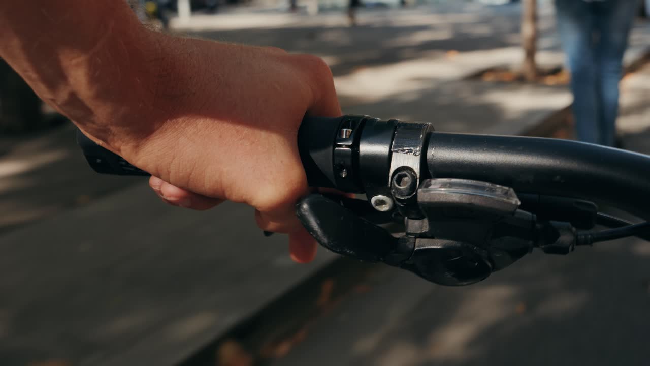 Close up of hand gripping bicycle handlebar
