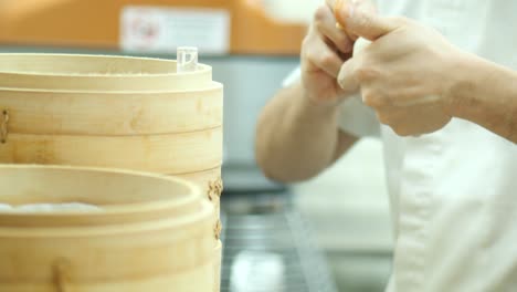 a chef hand making momo indoor ,