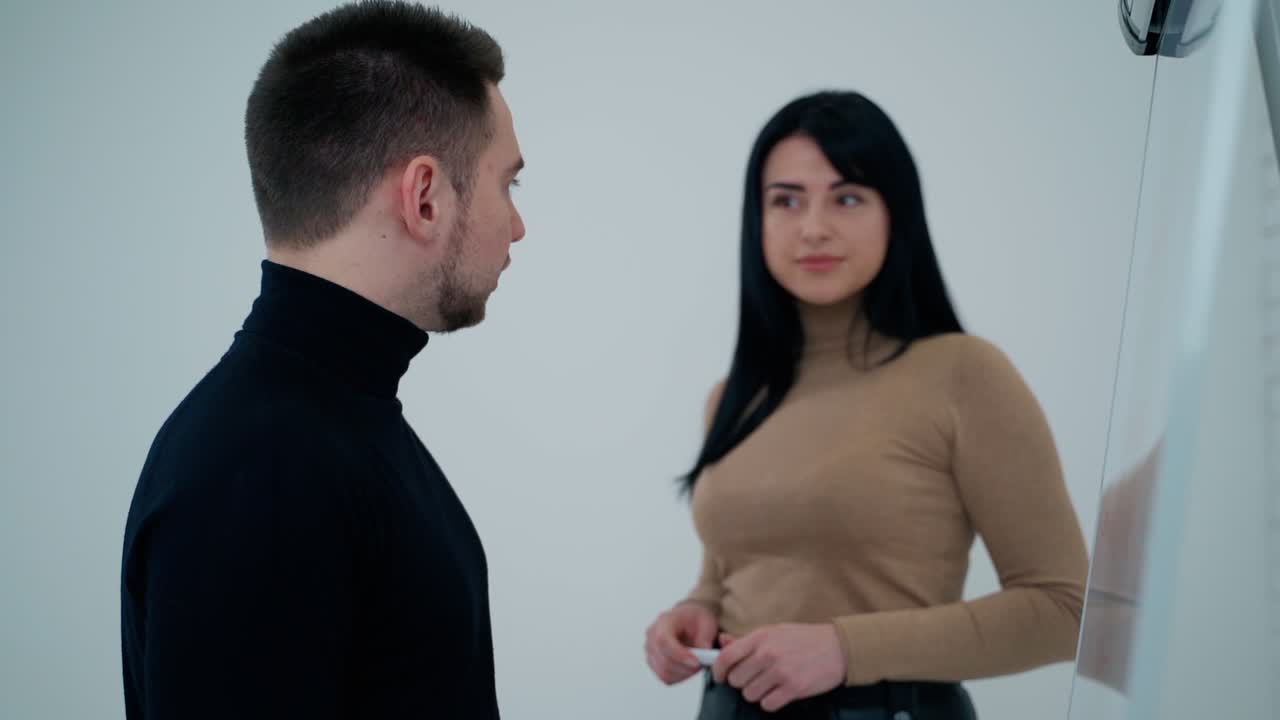 Businessman training speaker coach. Young businessman giving presentation on board