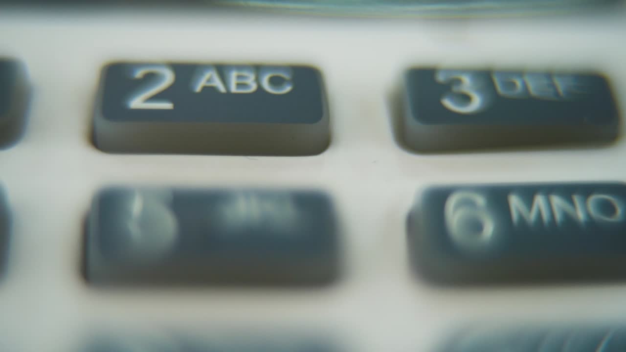A macro close up shot of a pin pad numbers and letters on colorful buttons, zooming in movement, Full HD video, super slow motion, blurry depth of field