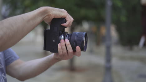 person holding and adjusting a camera