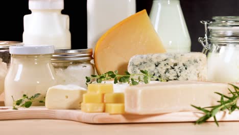 assorted dairy items arranged on a wooden board