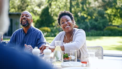 Family,-eating-and-lunch-in-garden-for-happy