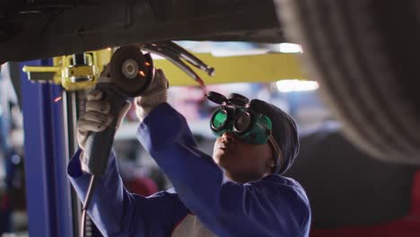 video of afrcian american female car mechanic using grinder
