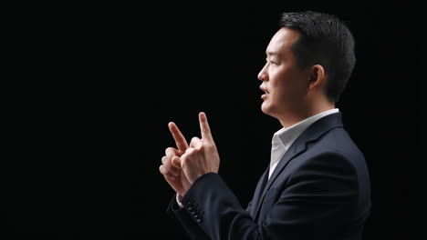 professional businessman gesturing and speaking on black background
