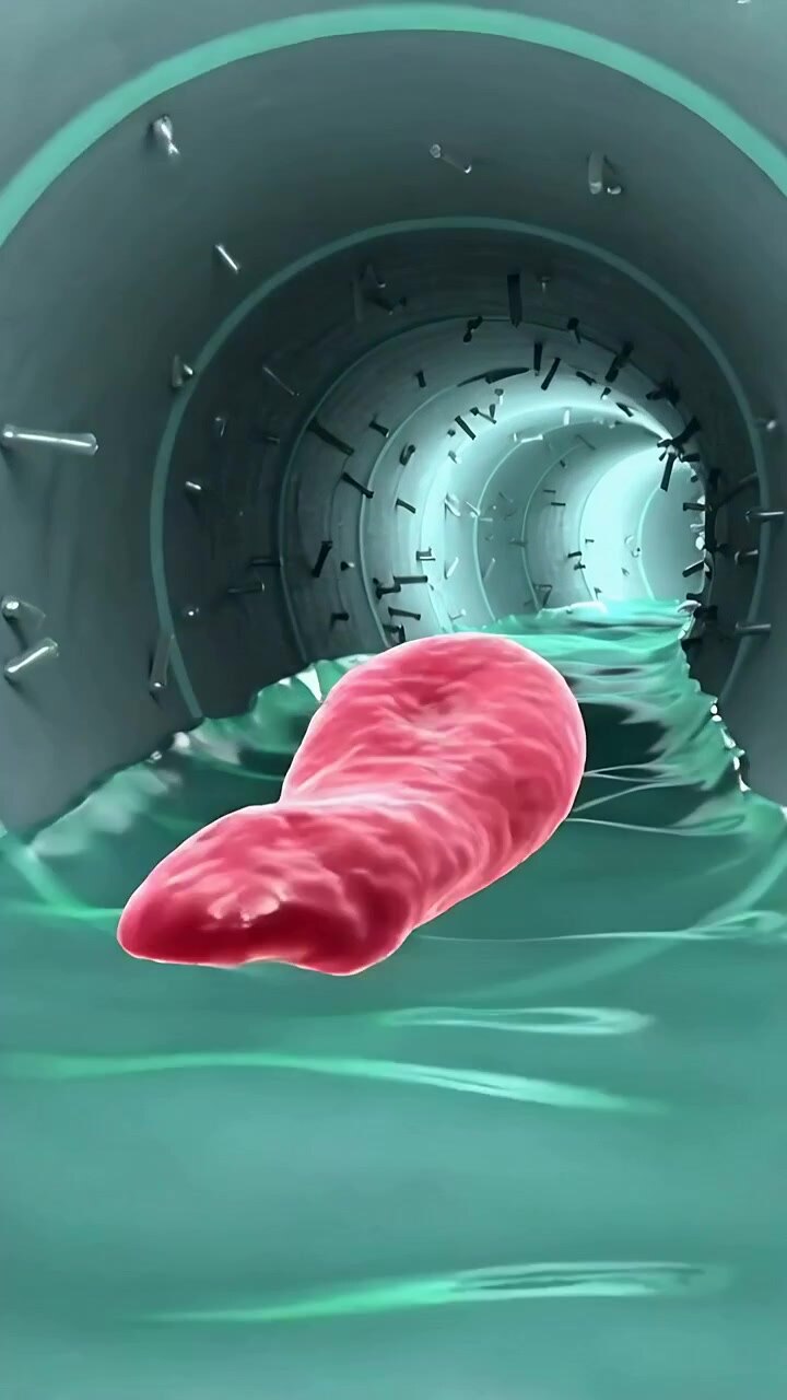 Vertical video: Gliding red object rotating in metal pipe, pushed by teal liquid and screws