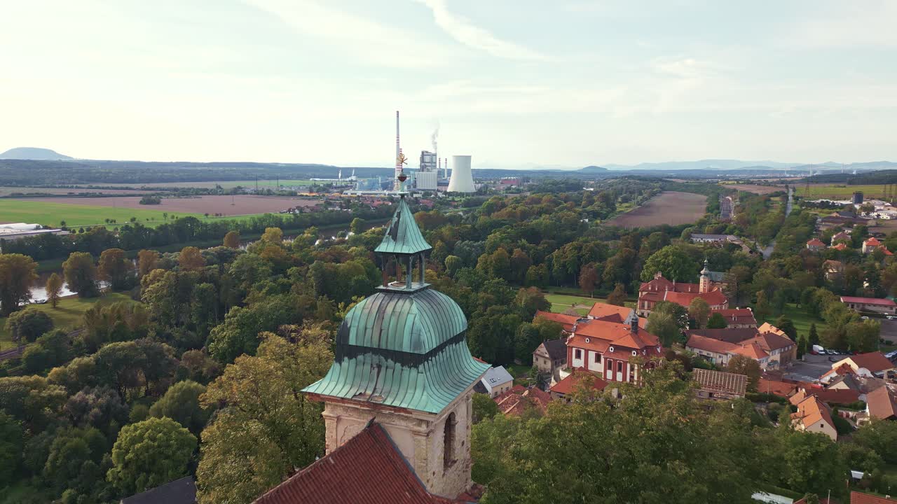 A drone camera flying backward reveals a skull on the tower of the Holy Ghost Chapel in Libechov