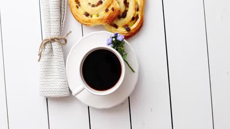 Delicious-pastry-with-raisins-and-a-cup-of-coffee-top-view-