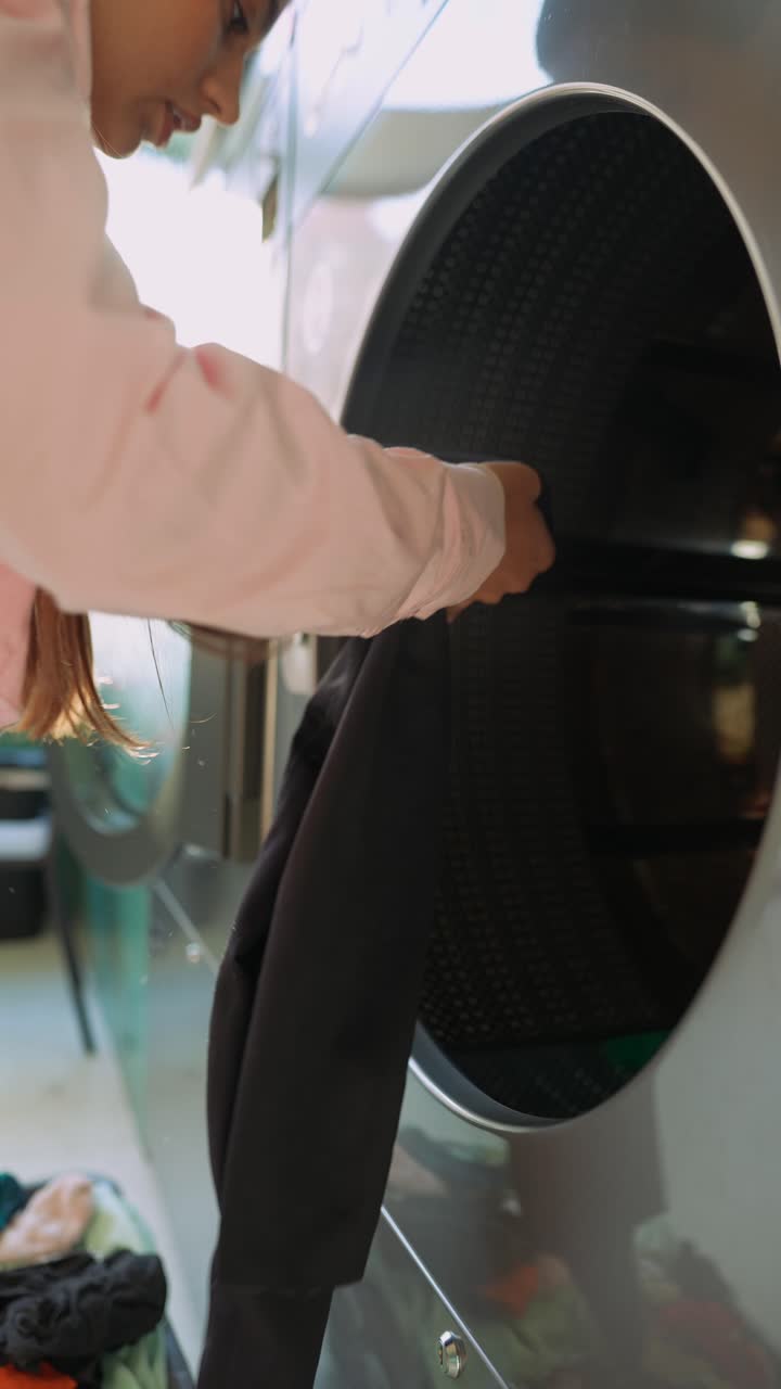 Woman Loading a Commercial Dryer