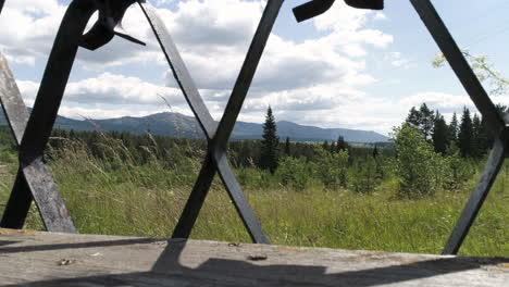 mountain view through a fence