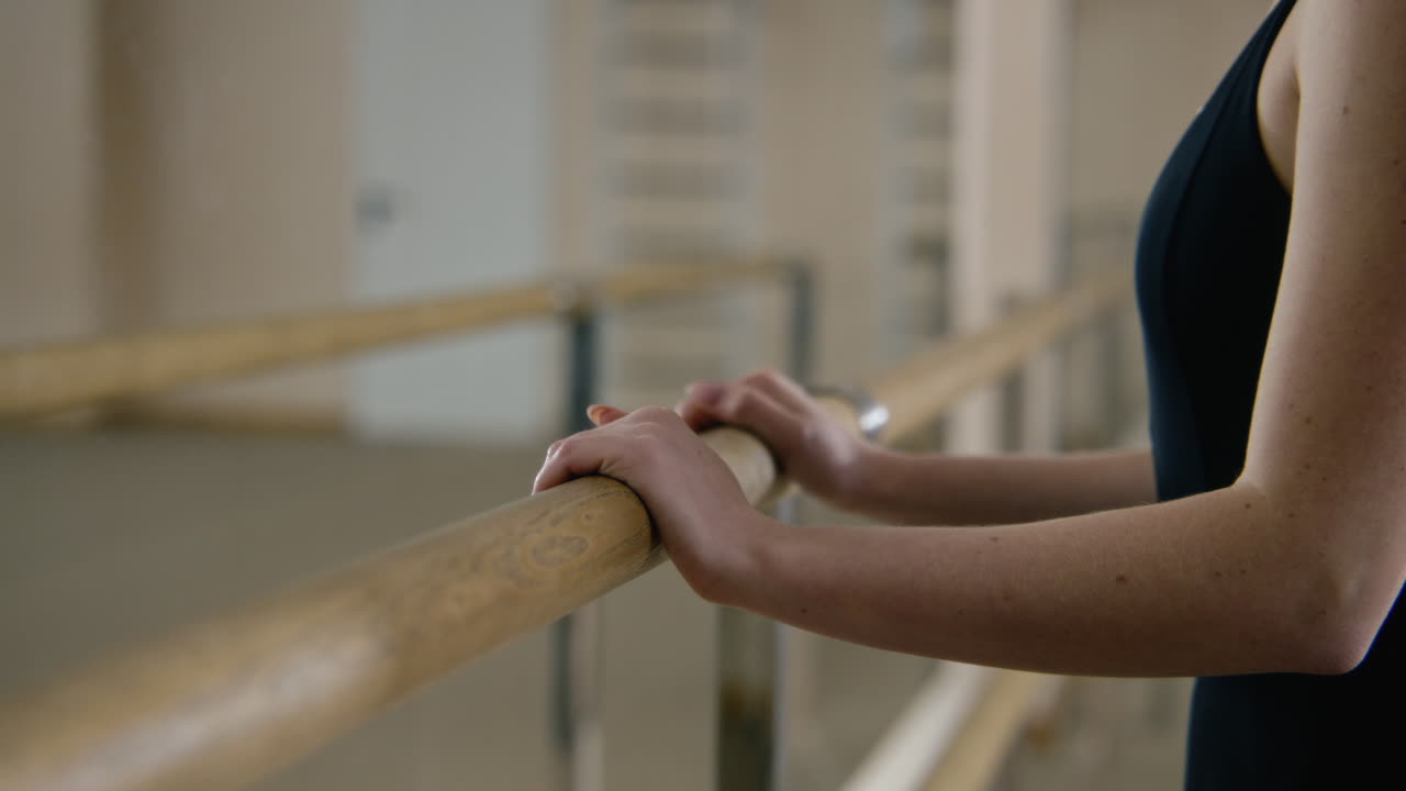Ballet Dancer Stretching at the Barre