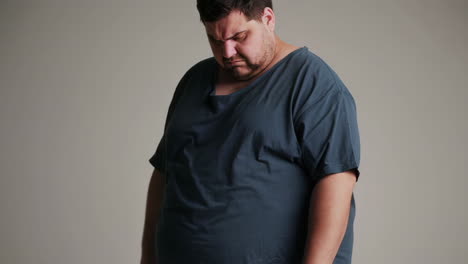 overweight man looking down