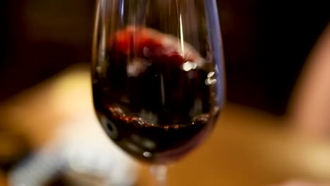 close-up of red wine swirling in glass