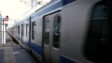 jr train is leaving the railway station in tokyo city