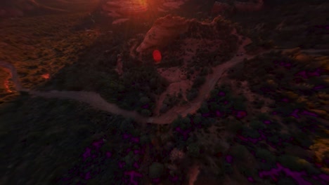 Zoom-in-Aerial-shot-during-dusk-of-a-mountain-peak-in-the-rocky-red-desert-of-Sedona,-Arizona