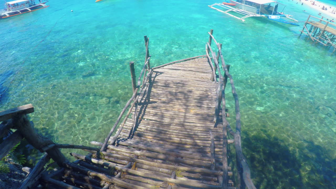 Relaxing View of a Bamboo Bridge and Clear Ocean Water at Sumilon Island, Cebu, Philippines