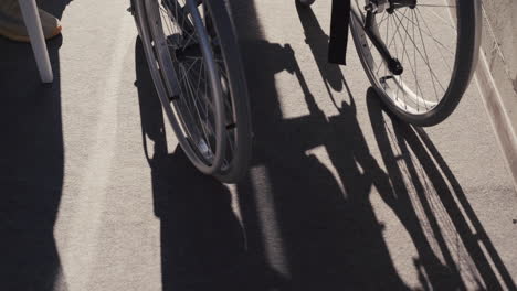 disabled man in wheelchair talking with his friend during a sunny day at home