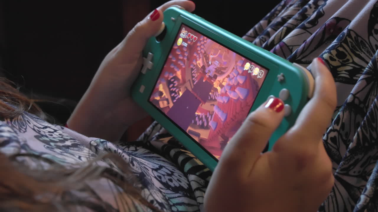 niña jugando sistema de videojuegos portátil