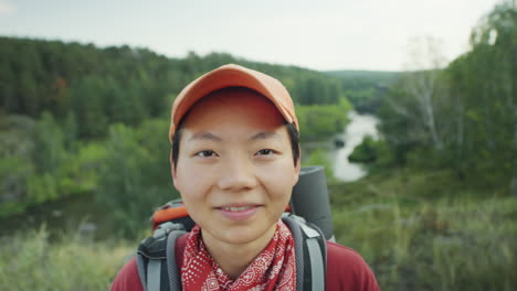 portrait of cheerful asian woman on hike