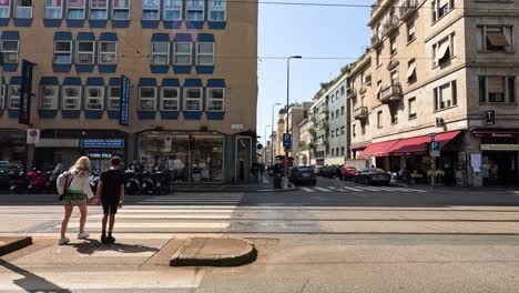 people crossing street in milan, italy