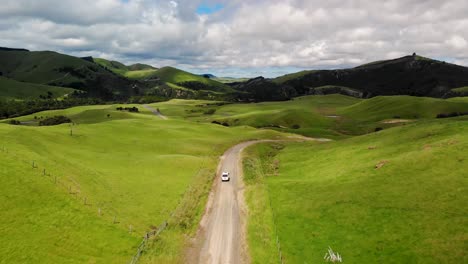 van driving on gravel road aerial tracking