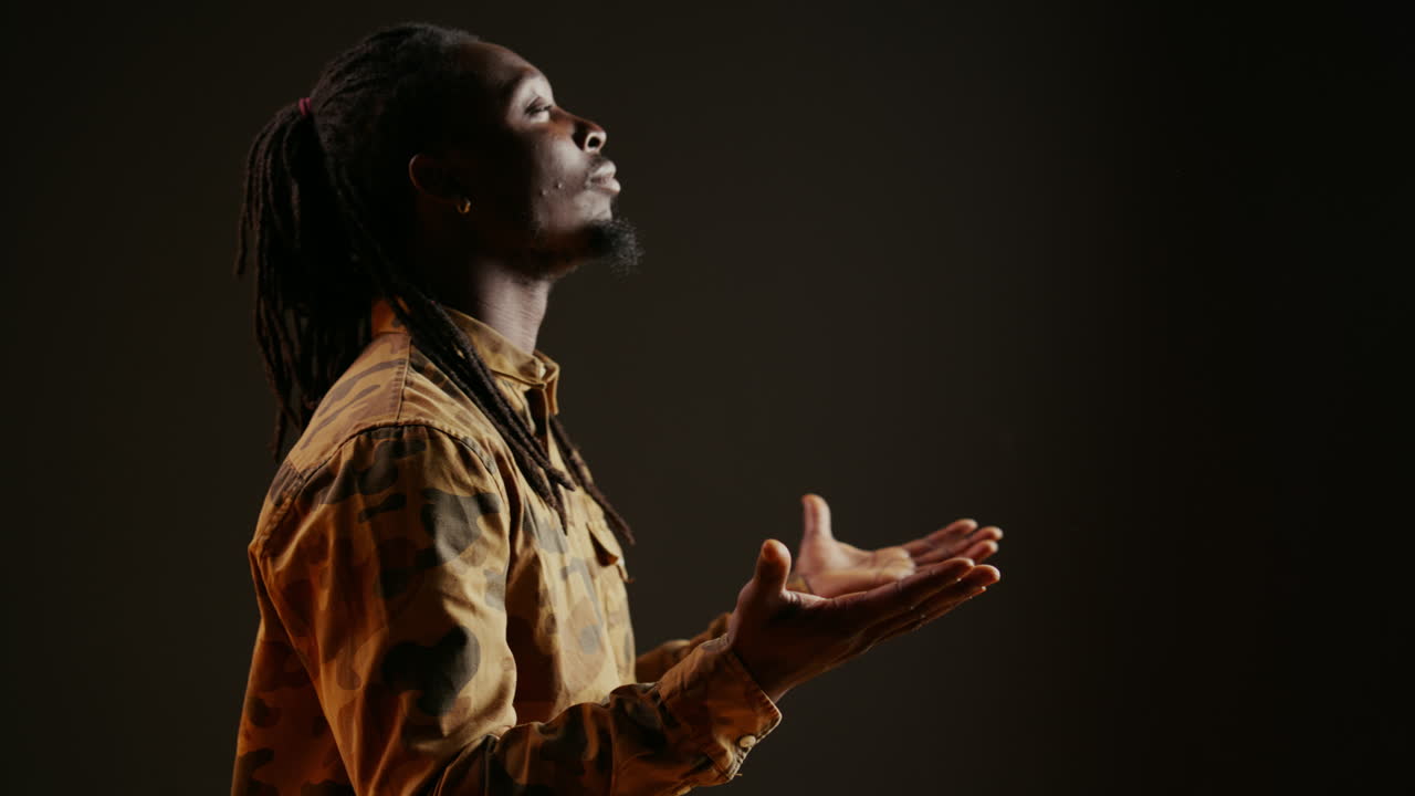 Spiritual person believing in God and praying on camera