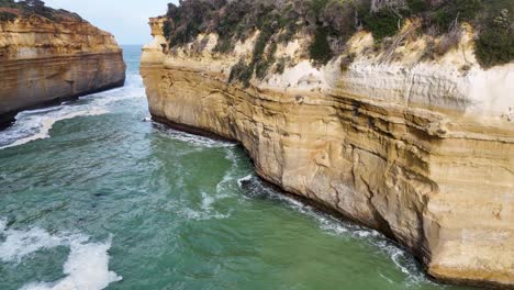 aerial footage of rugged cliffs and turquoise waters at loch ard gorge, showcasing natural beauty and dynamic ocean movement