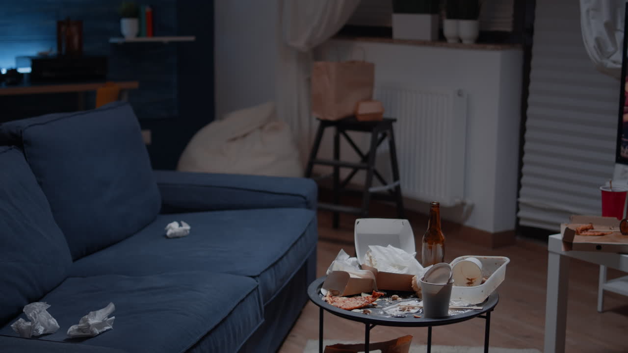 Close up of table with leftover on it in empty unorganized messy living room