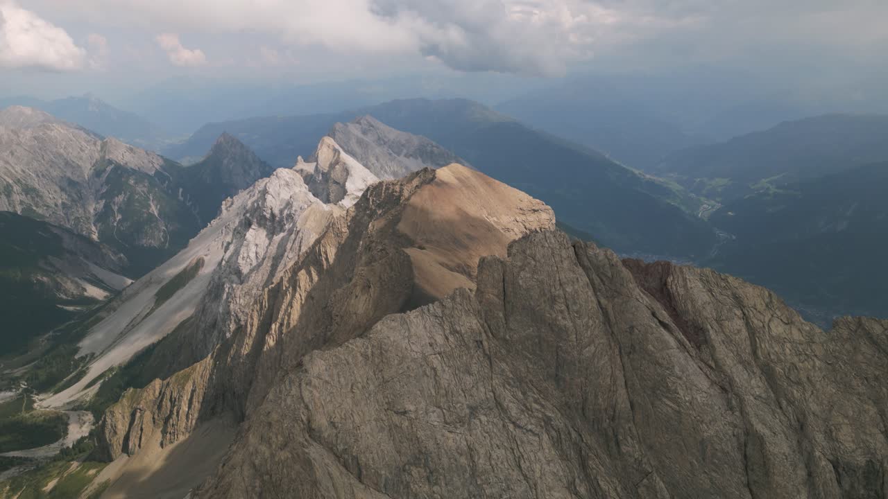 A majestic mountain at sunrise under a dramatic sky, peaceful and awe-inspiring