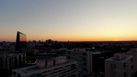 Aerial-of-sunset-below-horizon-on-Philadelphia-Pennsylvania-skyline-and-Schuylkill-River-during-summer-evening