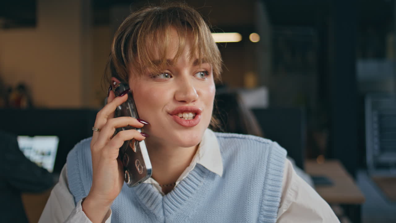 Smiling secretary smartphone conversation office closeup. Joyful woman speaking