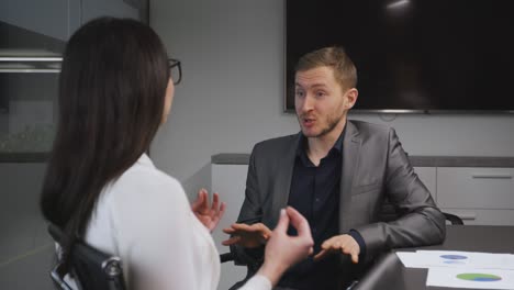 business misunderstandment. young man and woman partners quarreling at office, discussing company development strategy