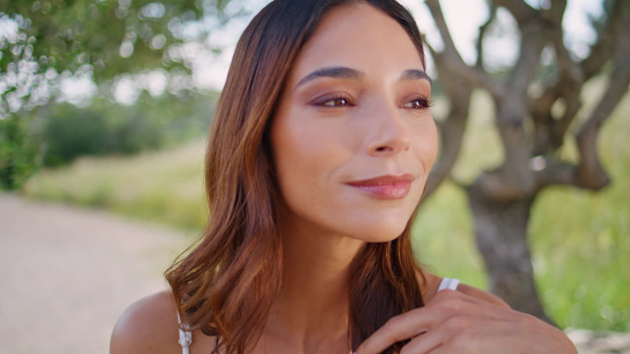 Joyful woman smiling park feeling content closeup. Portrait brunette resting